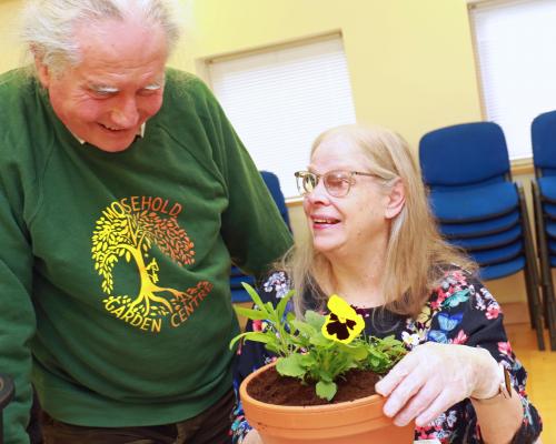 Tim Gee of Mousehold Garden Centre helps Annabel Clifton plant up her pot sm