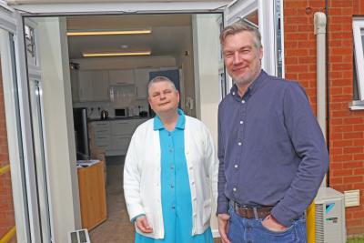 Hammond Court resident Kate Pentney outisde the patio doors of her flat with Vision Norfolk chief executive Andrew Morter