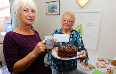 Norwich Housing Society scheme manager Sue Closs left with prizewinning baker Irene Young and her winning chocolate cake sm