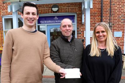 Paul Debenham centre presents a cheque for 1000 to Josh Bartholomew and Barbara Dunn of Vision Norfolk