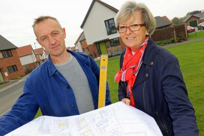 Stone carver Teucer Wilson and Maggie Abel of Abel Homes survey the site at Hingham where the new public artwork will be installed sm