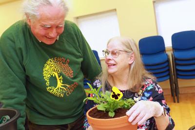 Tim Gee of Mousehold Garden Centre helps Annabel Clifton plant up her pot sm